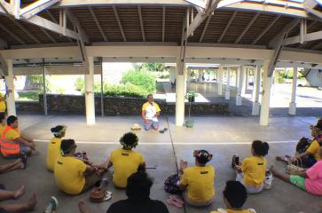 A proximité du temple octogonal de Papetoai, moments de partage et d’échange en reo tahiti entre le pasteur Maehaa, les étudiants de l’UPF et les enseignants accompagnateurs Leocadie Karine, Rochette Lovaina et Franck Taputuarai 